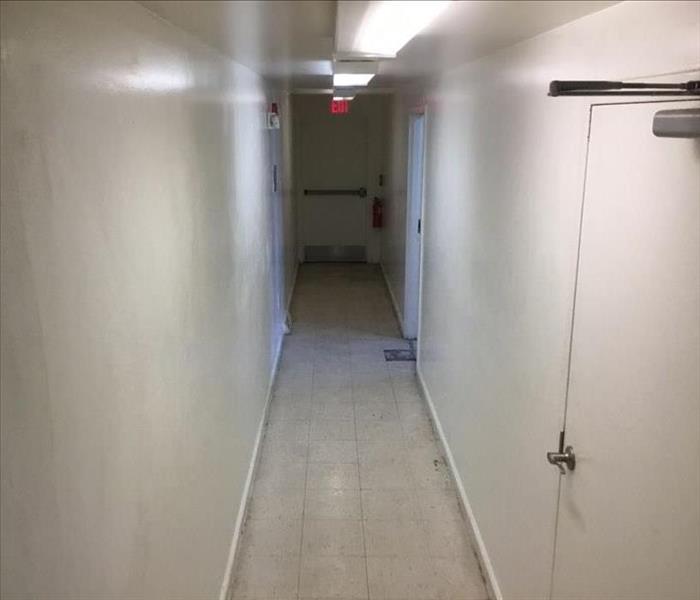 Clean hallway with white walls and floors