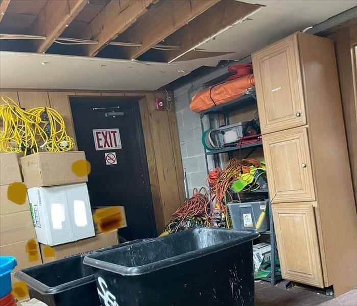 Storeroom with SERVPRO drying equipment and opened ceiling