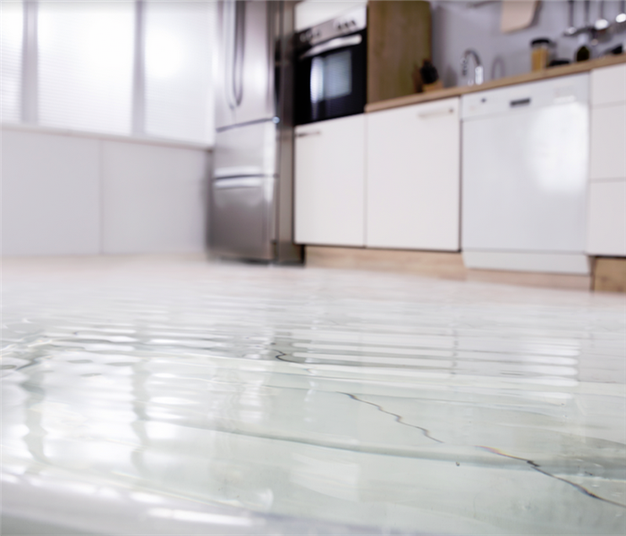 water covering the tile floor in a kitchen